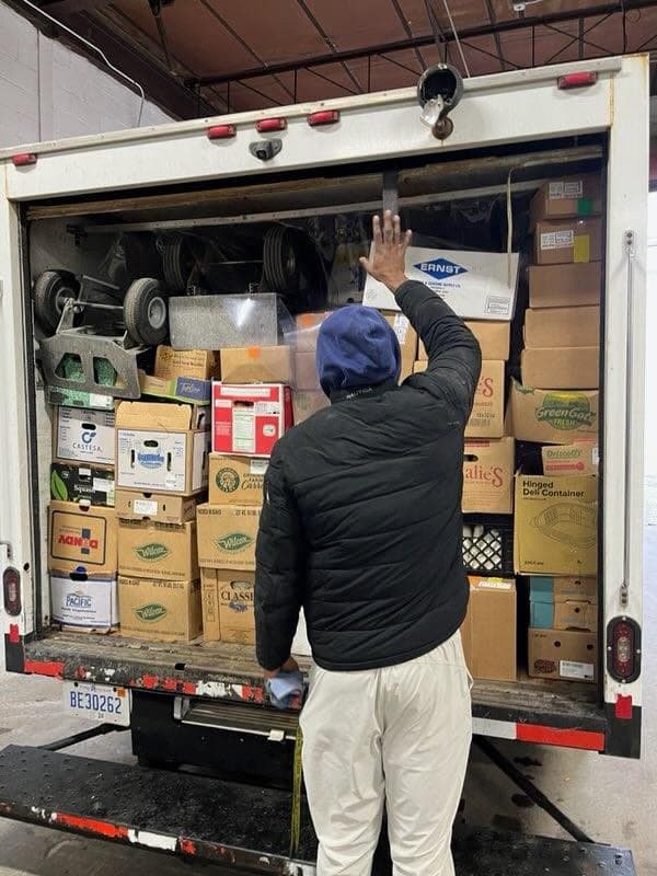 A packed delivery truck ready to leave with produce for customers